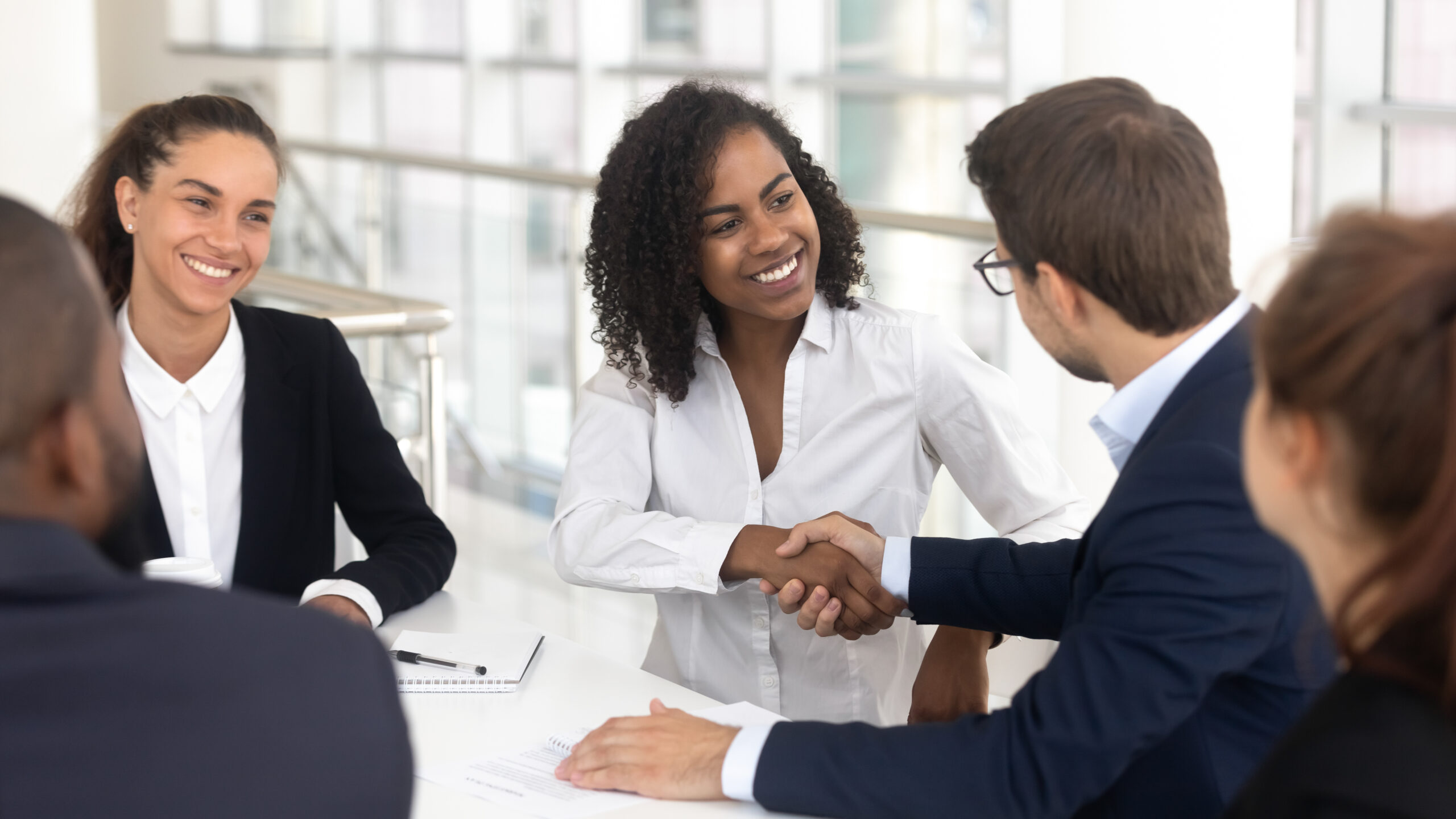 woman shaking hands in first job