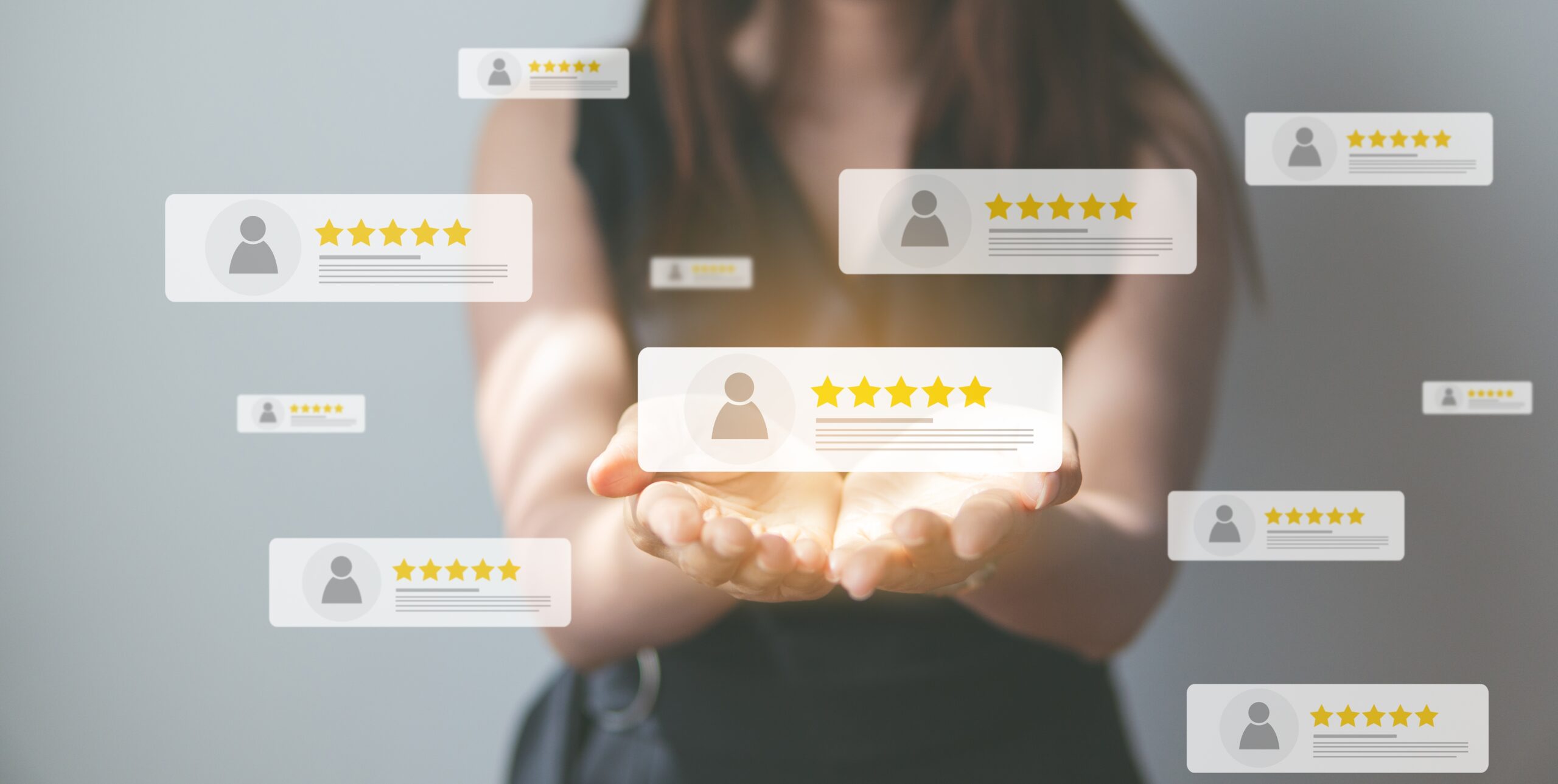 A person holding glowing star ratings representing positive customer feedback.