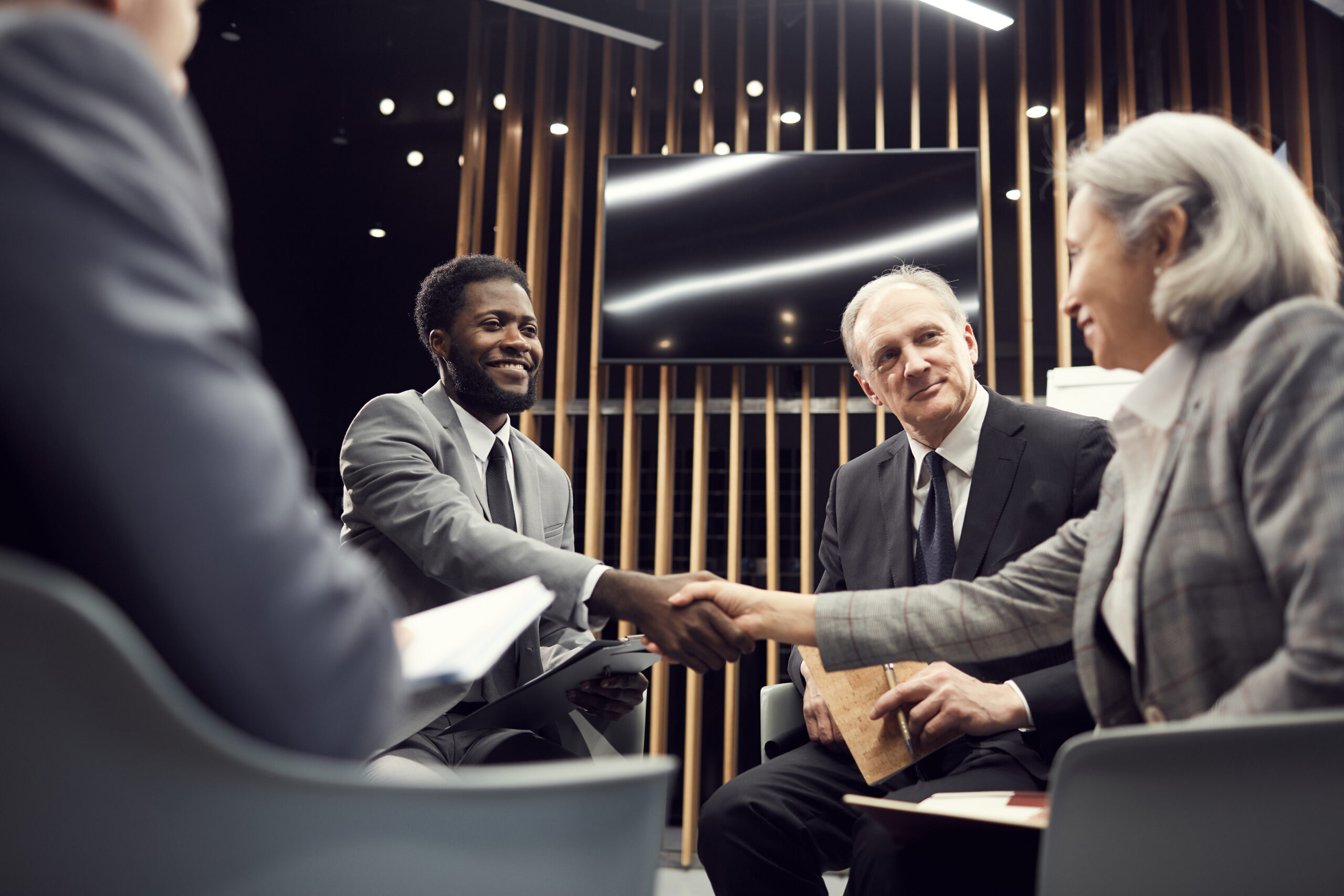 A customer-facing rep shaking hands with a client.